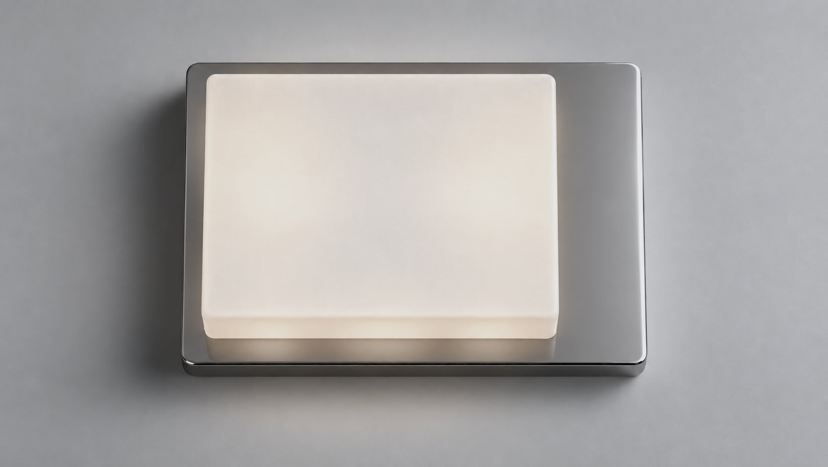 Table Light L01 seen from above: the lit alabaster block set towards one end of the polished aluminium base.
